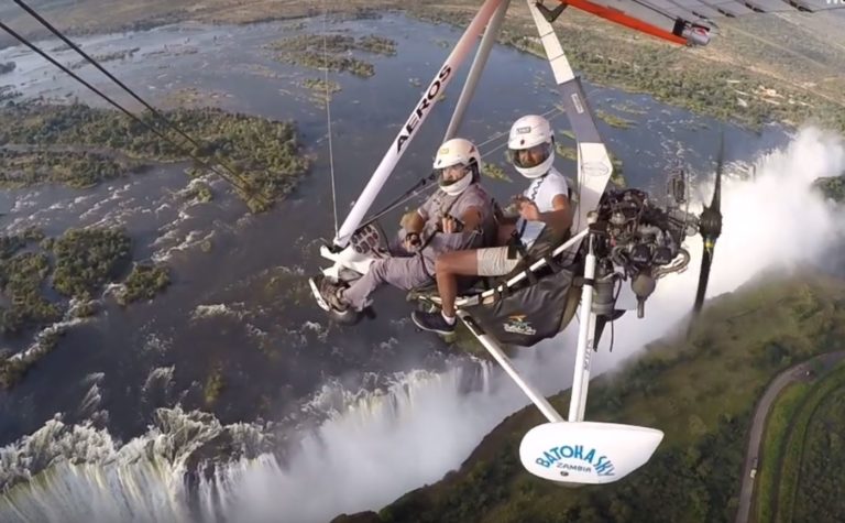 Posing for a Go-Pro picture as the Microlight flight hovers in front of the Victoria Falls