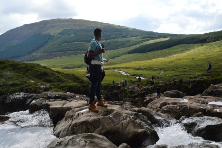 Standing on the rocks of the Fairy Pools