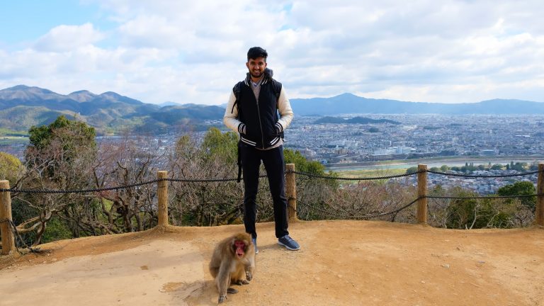 Standing next to a Japanese Snow Monkey with Arashiyama in background