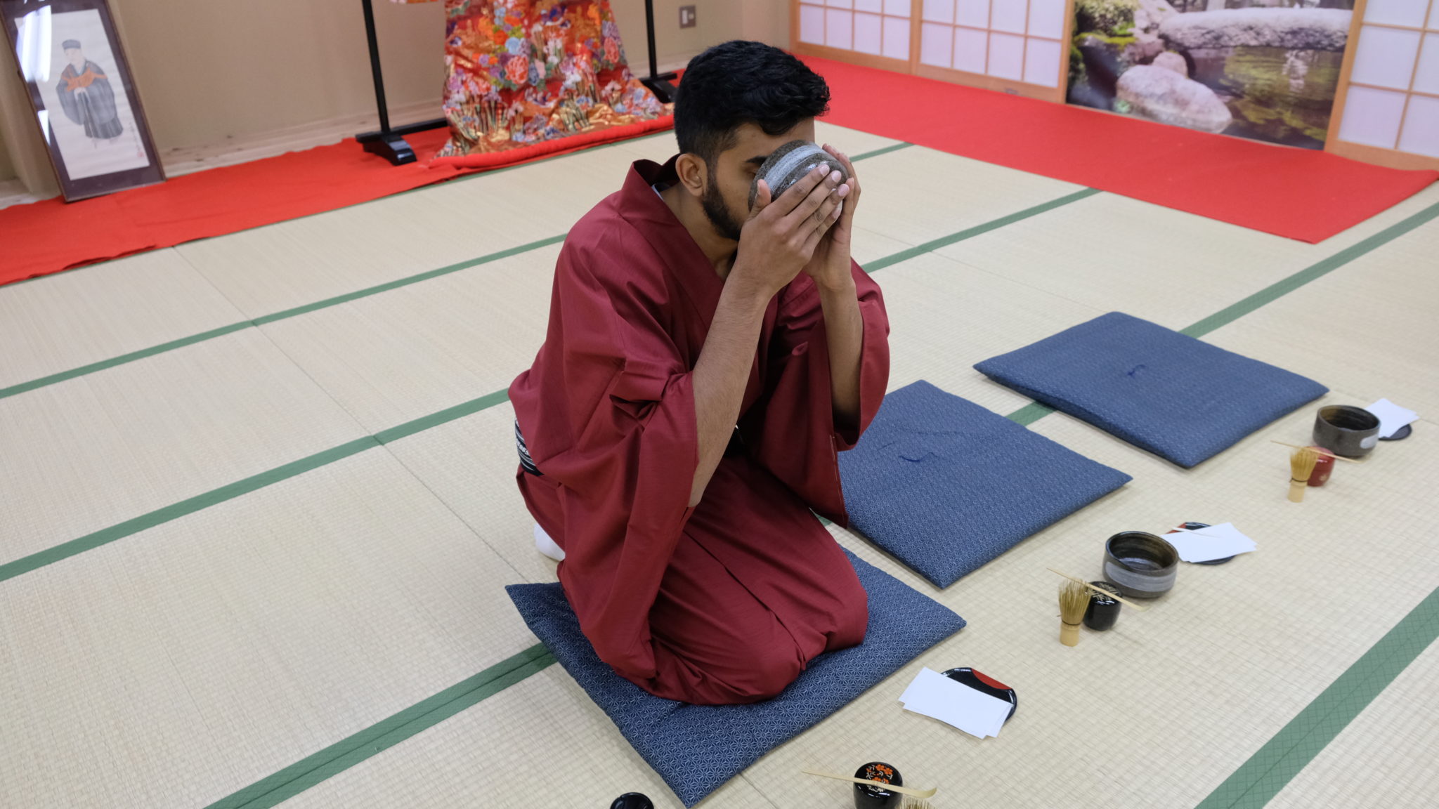 Sipping on matcha tea dressed in a red kimono