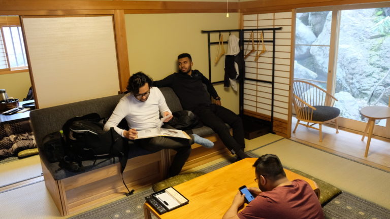 Three friends relax inside their room at the Eko-In temple