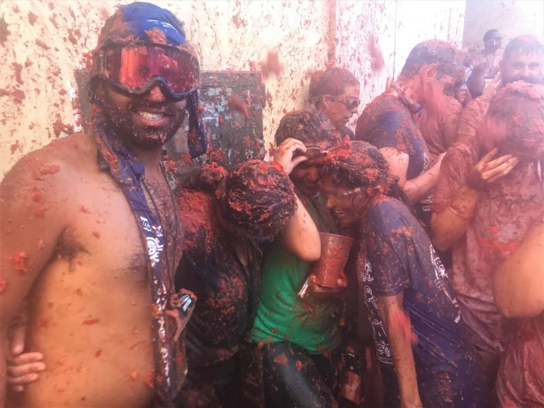 Standing for a picture as tomatoes fly at us at La Tomatina