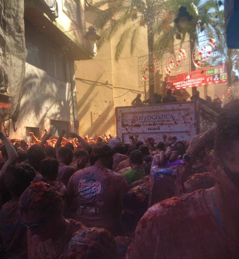 Truck drives by as tomato fight breaks out on streets of bunol