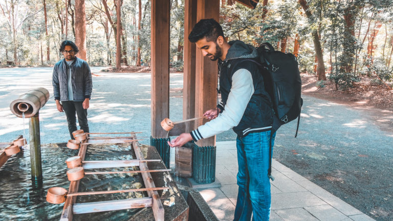Nishil washing his hands before entering shrine