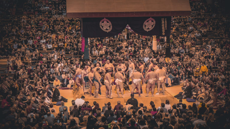 Sumo wrestlers circle up on the stage