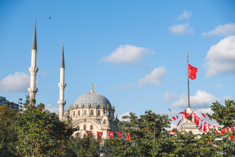 A mosque in Istanbul sits in front of a blue sky backrop