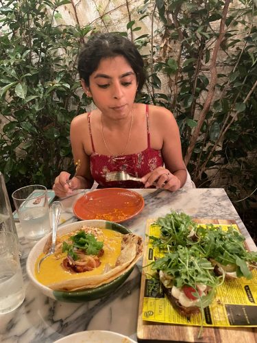 Anmol looks at food places on table of Espice restaurant